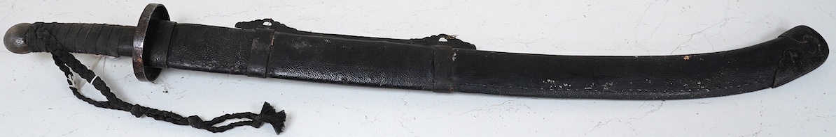 A Chinese Boxer Rebellion period sword, broad single edge blade, iron mounts, in its fish skin covered scabbard with iron mounts, blade 73.5cm. Condition - good